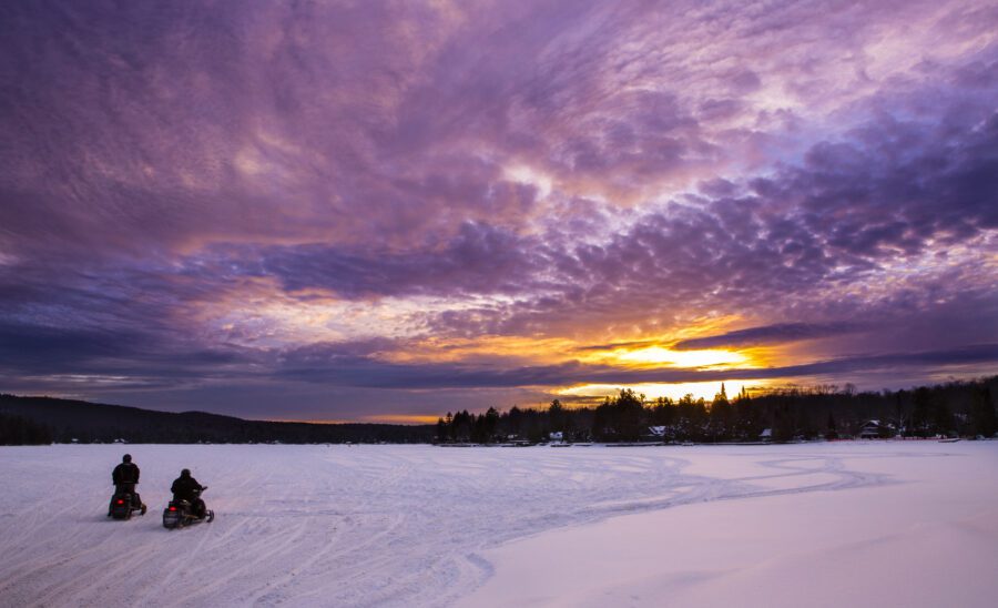 snowmobiles at sunset