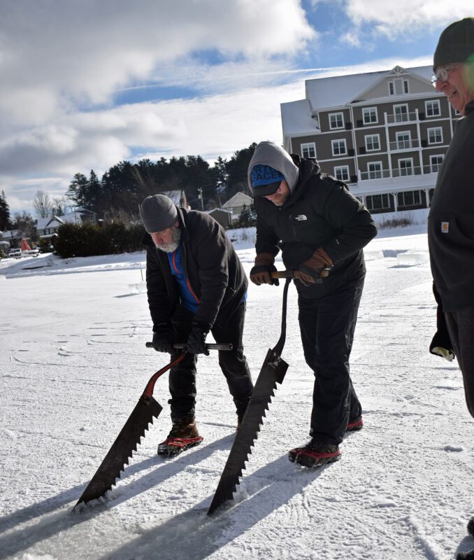 Members of the International Palace Workers Local 101 hand saw the first blocks from Pontiac Bay in Saranac Lake along grooves previously scored with the 1939 buzz saw 