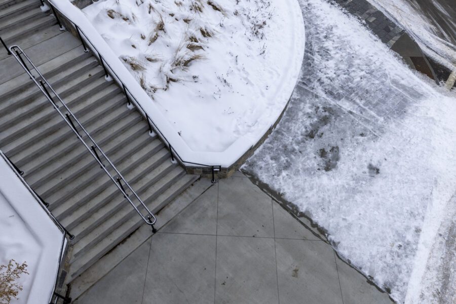 snow-free sidewalk and stairs outside the olympic rink