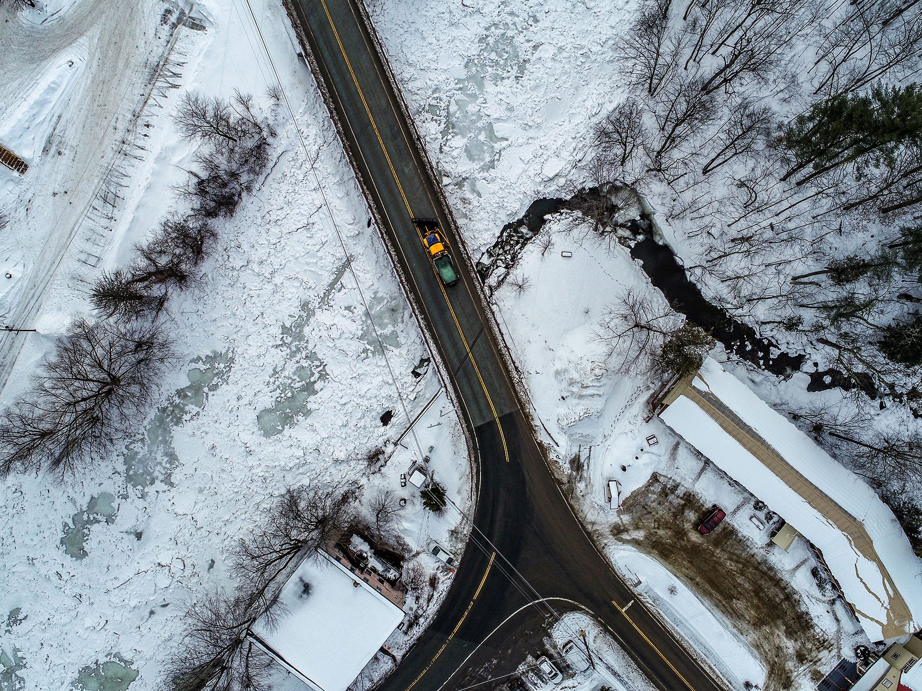 aerial shot of a road salt truck on a highway