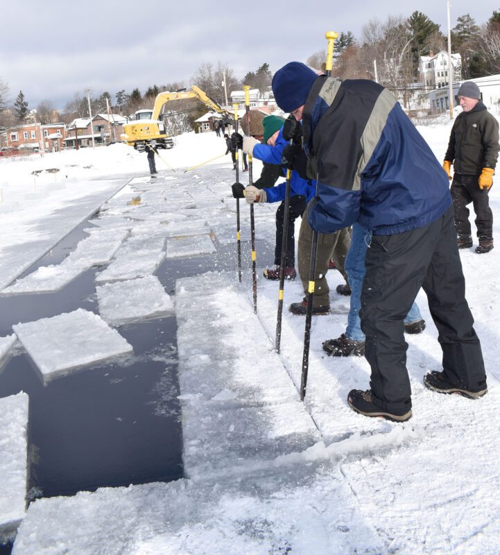 Ice and snow fly as members of the International Palace Workers Local 101 spud three blocks in unison