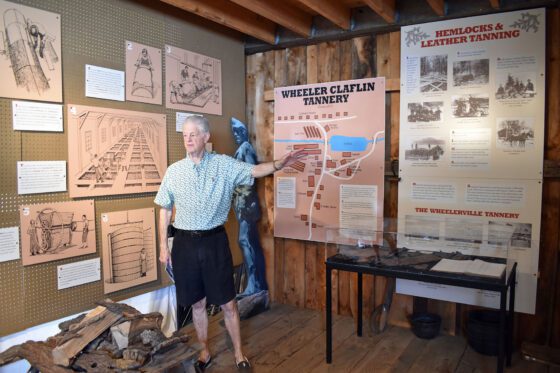 man explaining a tanning exhibit
