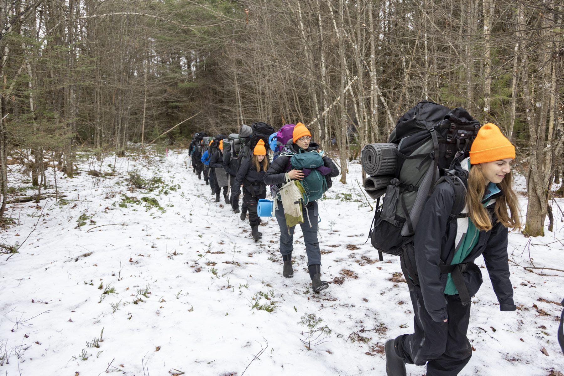 Lake Placid students tromp out of the woods toward the end of a camping trip. Photo by Mike Lynch