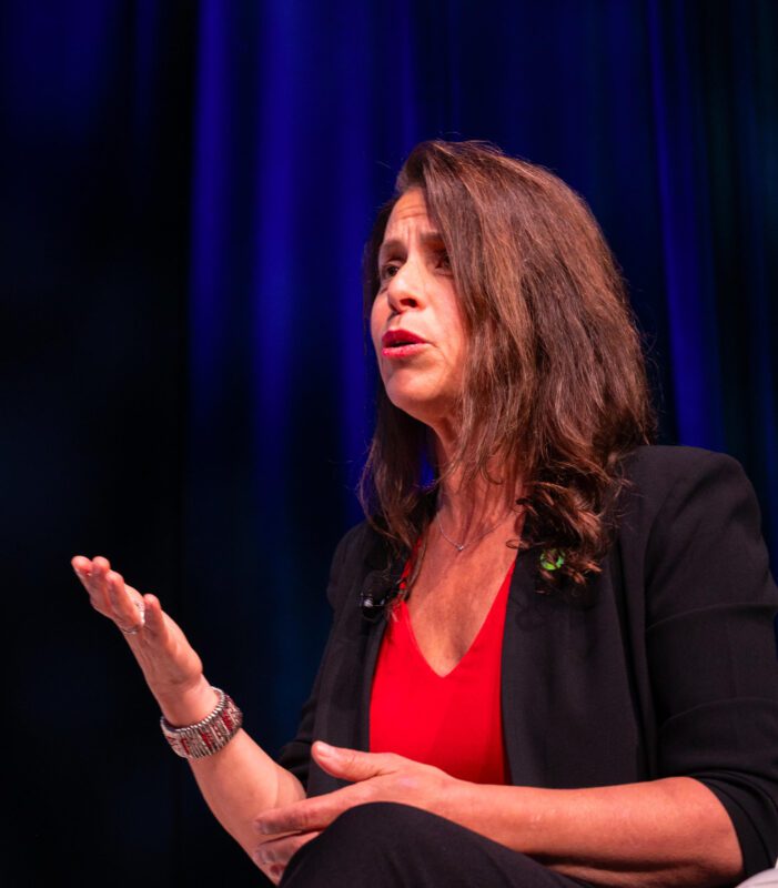 Harriet Shugarman speaks on a stage