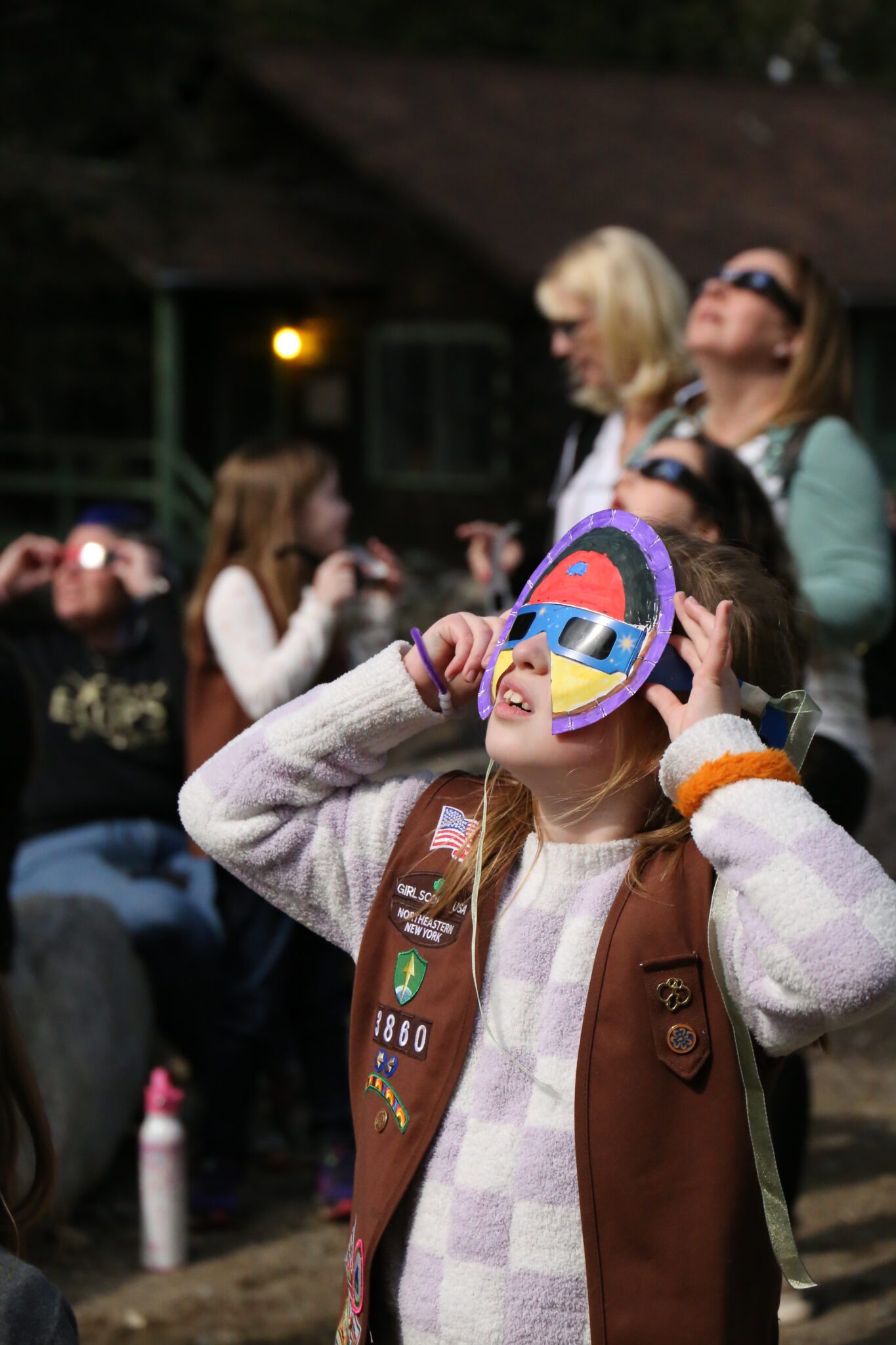 Eight-year-old Adeline Edson, of Clifton Park, made a superhero mask out of her eclipse glasses. She watched Monday's solar eclipse with the Girl Scouts of Northeastern New York and their families at Hidden Lake Camp in Lake Luzerne