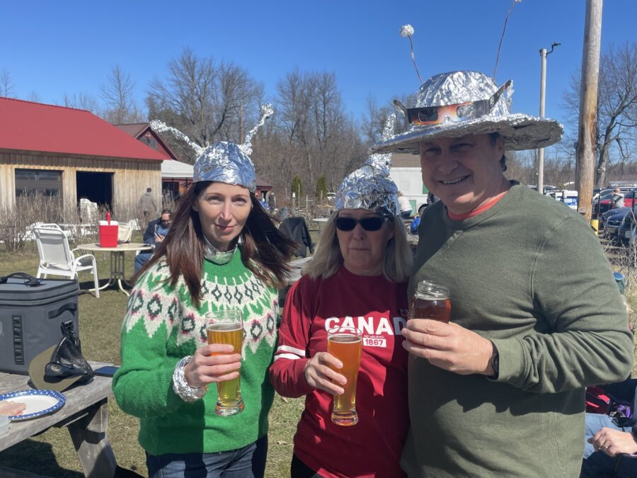 three people with beer and tin foil hats