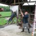 artist ted cornell at work on his art farm