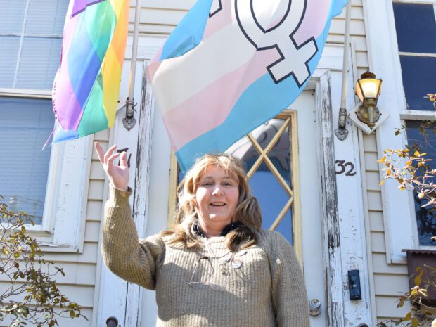 LGBTQ activist Kelly Metzgar stands with her Pride flags.