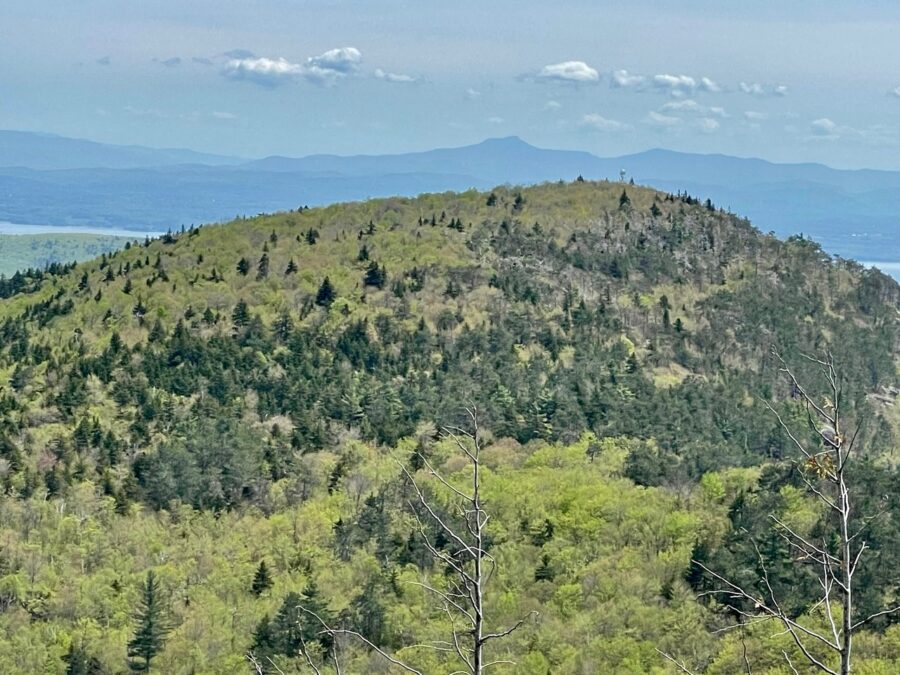 The fire tower on Poke-O-Moonshine appears just to the right of Camel’s Hump in the Green Mountains of Vermont.

