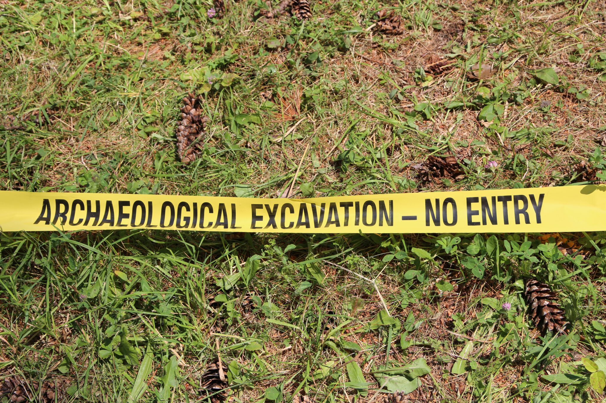 An archaeological test pit is cordoned off at the Lake George Battlefield Park