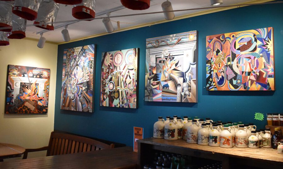 A room with a gallery wall and maple syrup for sale.