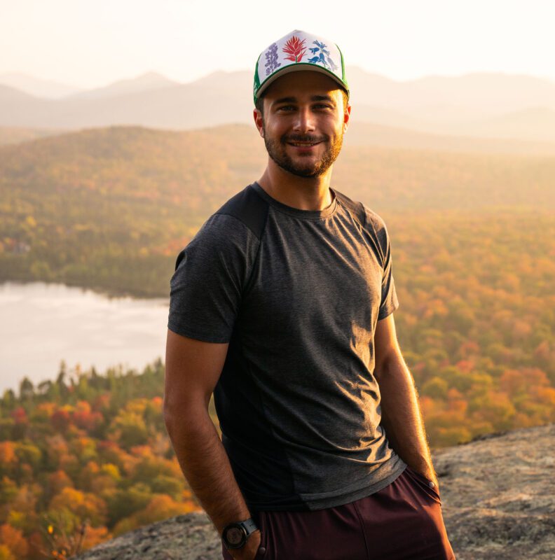 man on a mountain top in fall