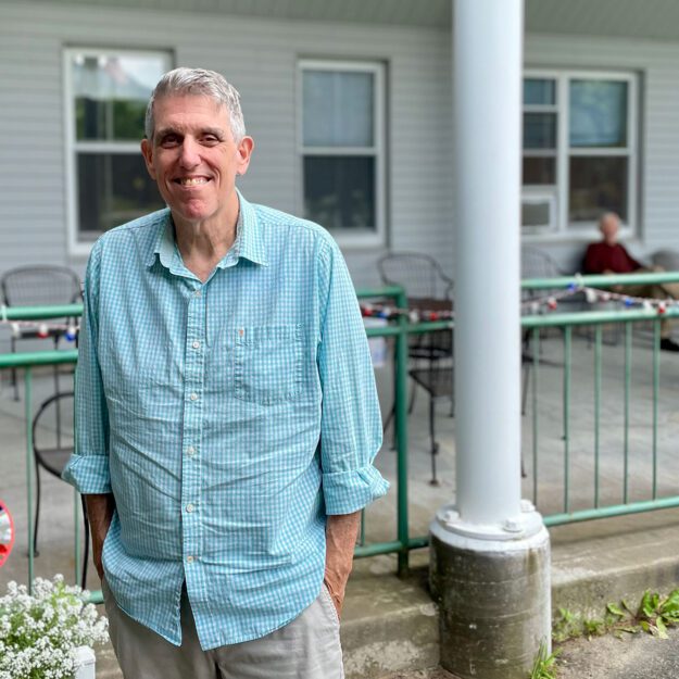 man standing in front of assisted living facility in Keene Valley