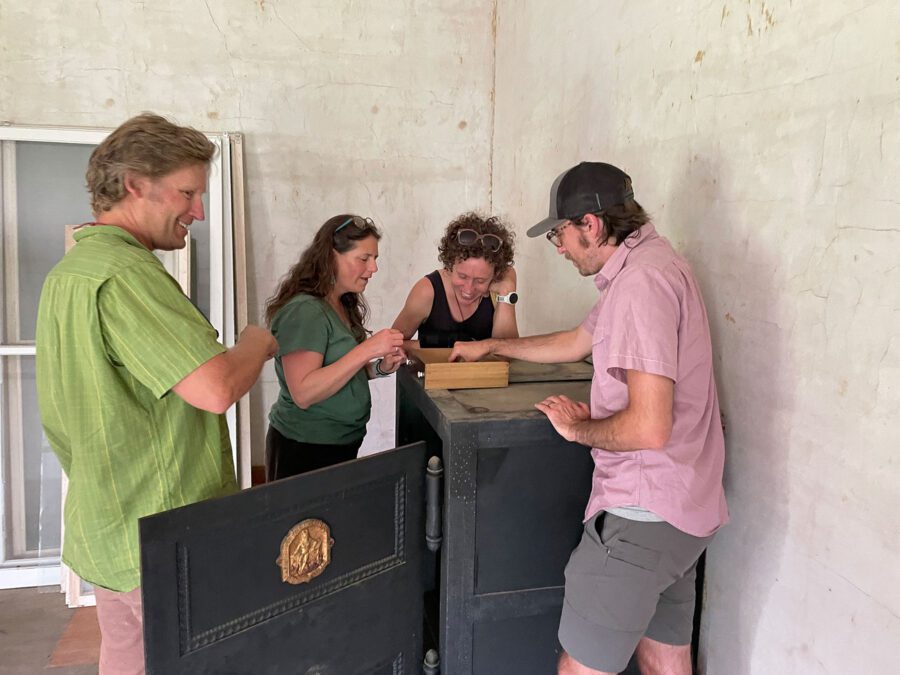 A group of people around an old safe