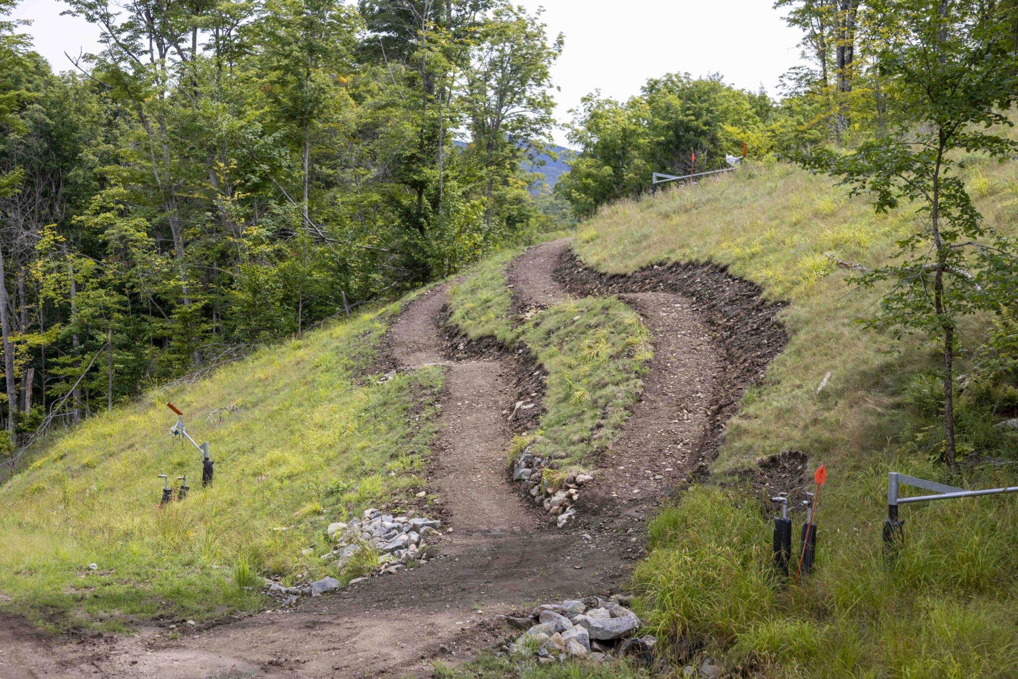 An uphill section of the new bike course marked by grooves in the dirt at Mount Van Hoevenberg