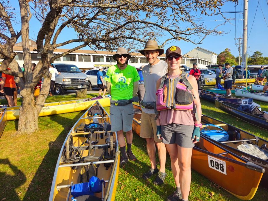 three people by a canoe