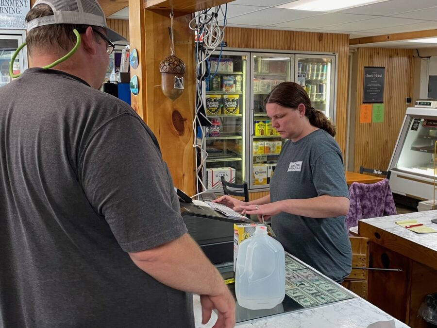 woman in a store running a cash register