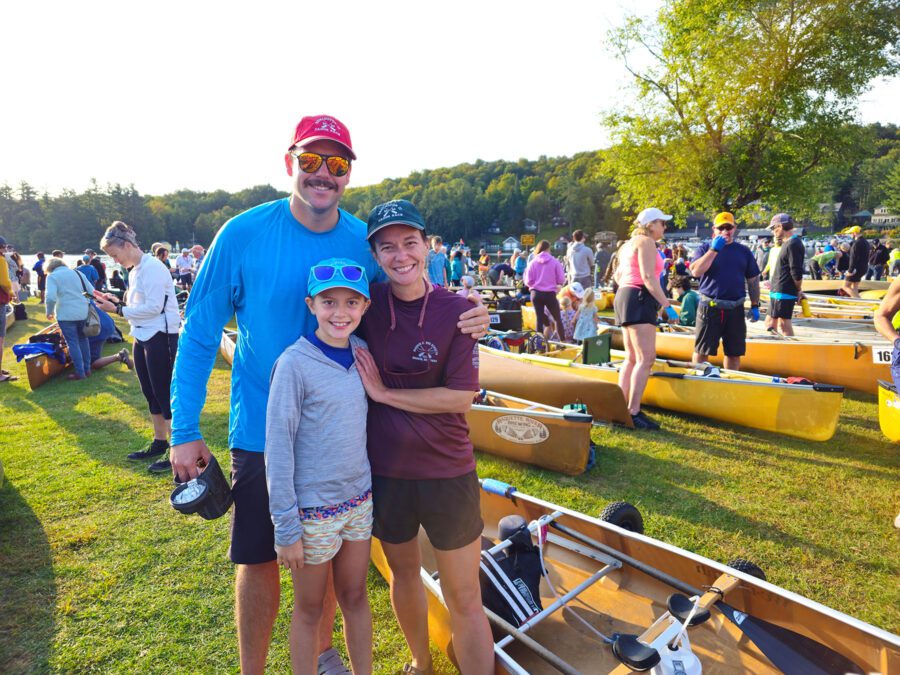 family posing with their canoe before the start of the 90-Miler canoe race
