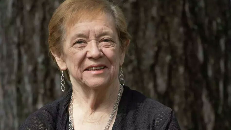 Edinburg town Supervisor Jean Raymond is retiring after more than three decades leading the town. She's wearing black and standing against a tree