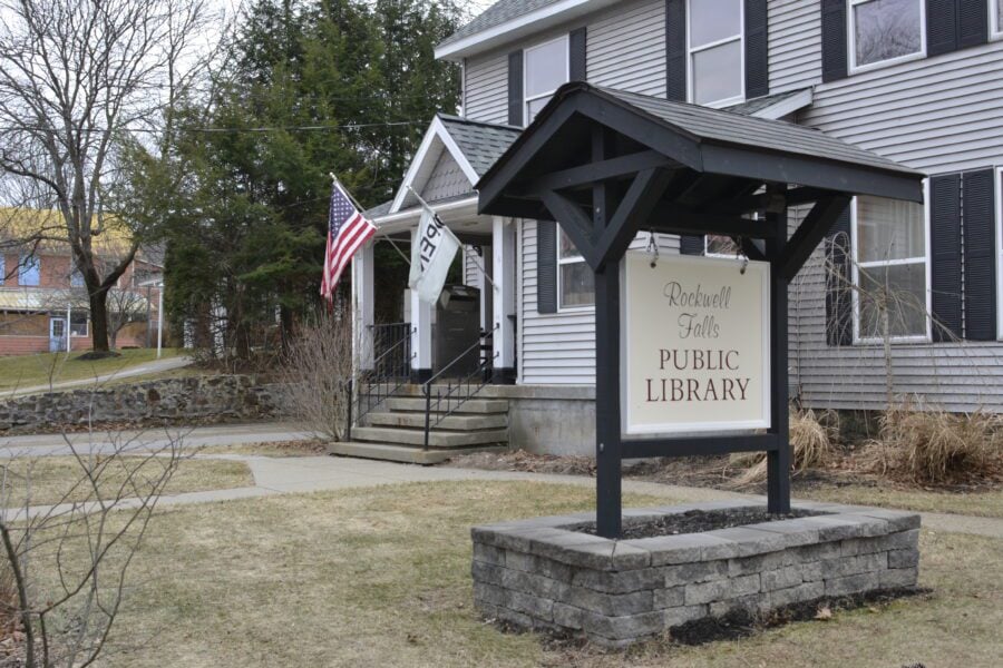 exterior of rockwell falls public library, with sign in the foreground