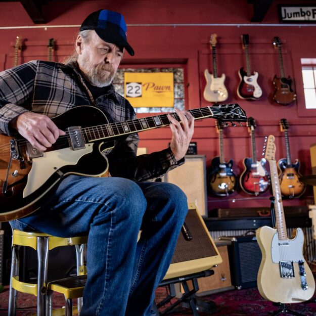 Ralph Lane, multi-instrumentalist and luthier from Crown Point, playing a 1959 Kay Barney Kessel, named after the American jazz guitarist, at 22 Pawn in Essex.