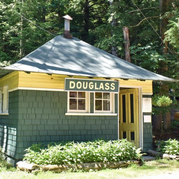 green and yellow historic cabin with "Douglass" on it