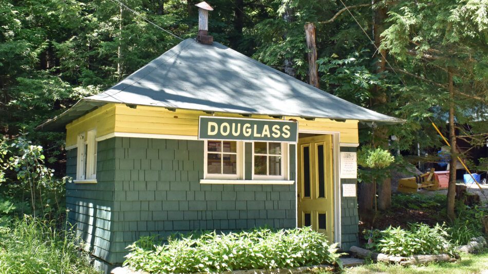 green and yellow historic cabin with "Douglass" on it