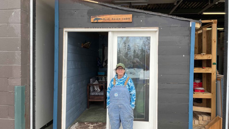 Deb Naybor stands outside of the Blue Raven Cabin. The tiny home is being built by Paul Smith's College students as a capstone project. Photo by Rick Karlin