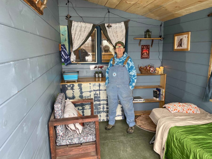 Deb Naybor inside of the Blue Raven Cabin tiny home. Photo by Rick Karlin
