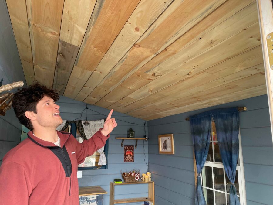 Michael Hansen showing off the interior of the tiny house. Photo by Rick Karlin