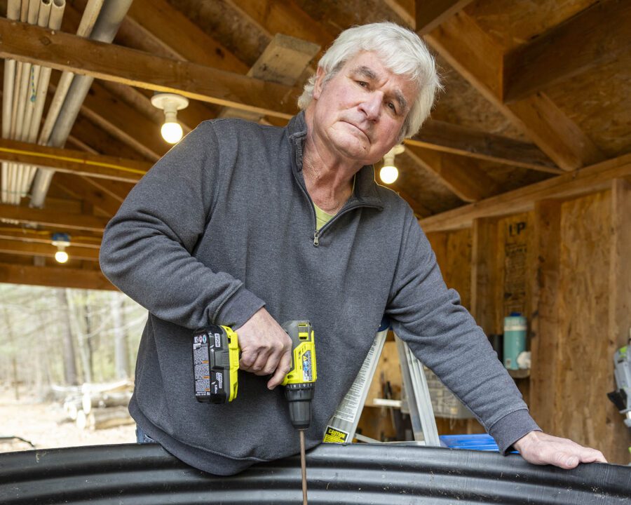 man with drill looking at camera