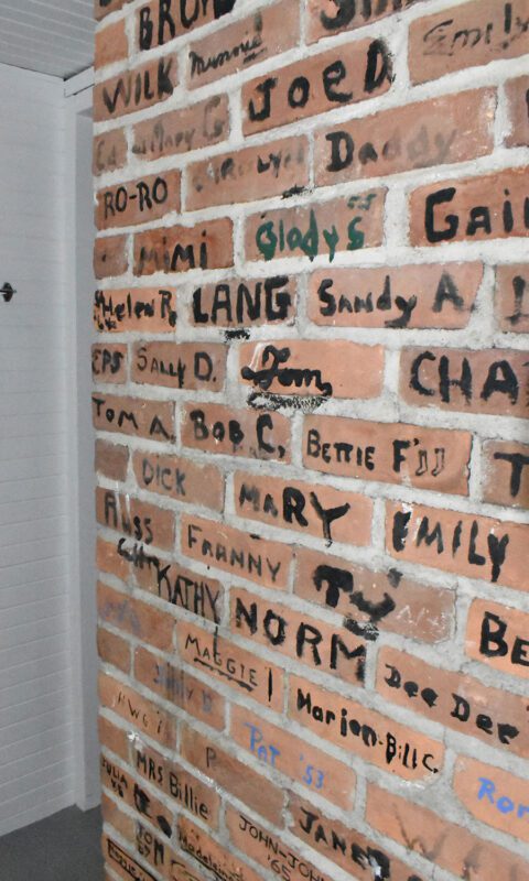 brick wall with signatures on it