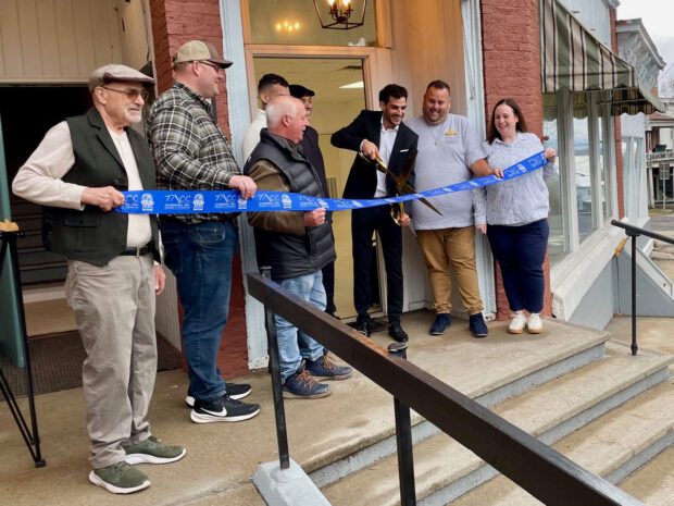 Yaron Badichi cuts the ribbon on refurbished commercial and apartment space. Photo by Caitlin Wargo
