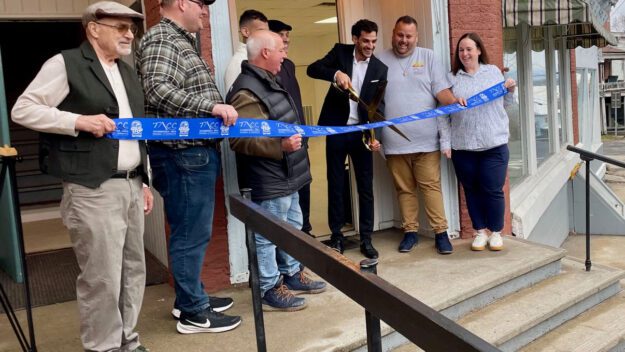 Yaron Badichi cuts the ribbon on refurbished commercial and apartment space. Photo by Caitlin Wargo