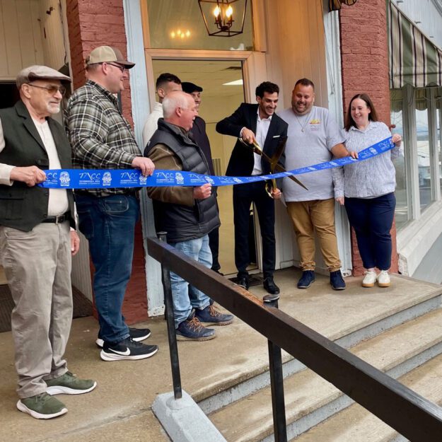 Yaron Badichi cuts the ribbon on refurbished commercial and apartment space. Photo by Caitlin Wargo