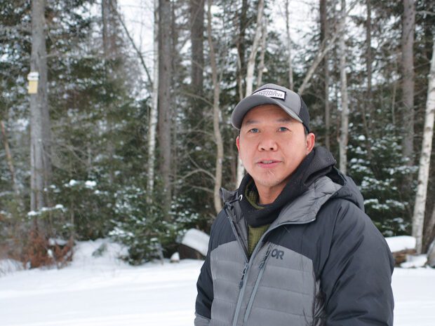Man in the snowy woods in winter gear