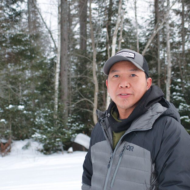 Man in the snowy woods in winter gear