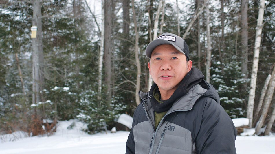 Man in the snowy woods in winter gear