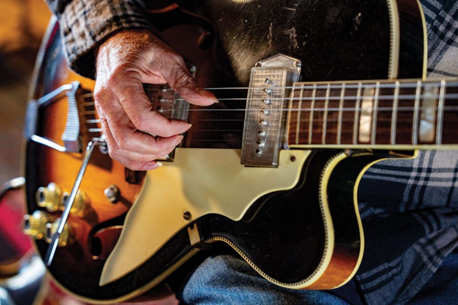 Hand playing guitar close-up