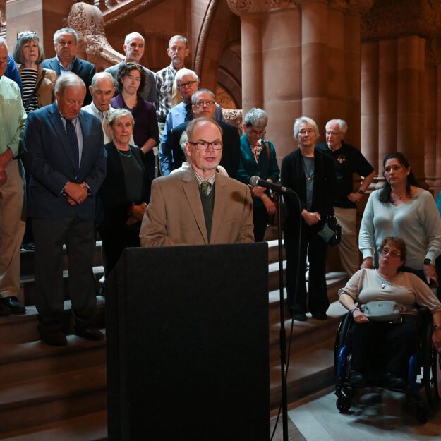 Dr. John Rugge speaking at a Medicaid press conference at the New York State capitol