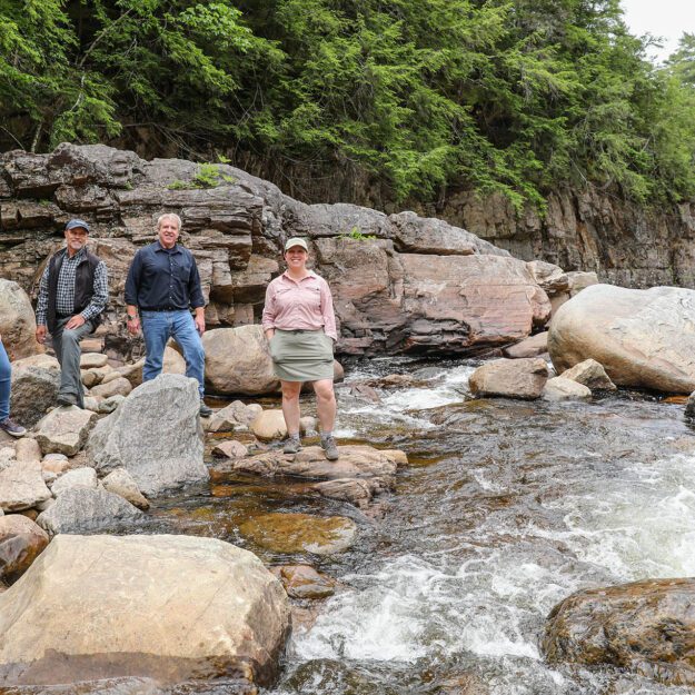 From left, Hamilton County IDA Executive Director Christy Wilt, Hamlets to Huts Executive Director Joe Dadey, local government leader Bill Farber, and ALT's Megan Stevenson at Griffin Gorge on the East Branch of the Sacandaga River in the town of Wells. Erika Bailey, courtesy Adirondack Land Trust
