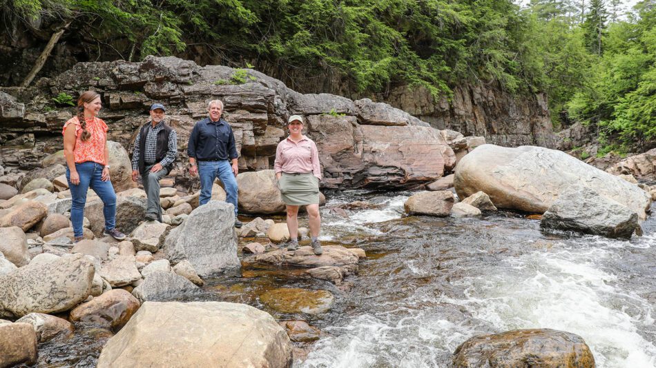 From left, Hamilton County IDA Executive Director Christy Wilt, Hamlets to Huts Executive Director Joe Dadey, local government leader Bill Farber, and ALT's Megan Stevenson at Griffin Gorge on the East Branch of the Sacandaga River in the town of Wells. Erika Bailey, courtesy Adirondack Land Trust