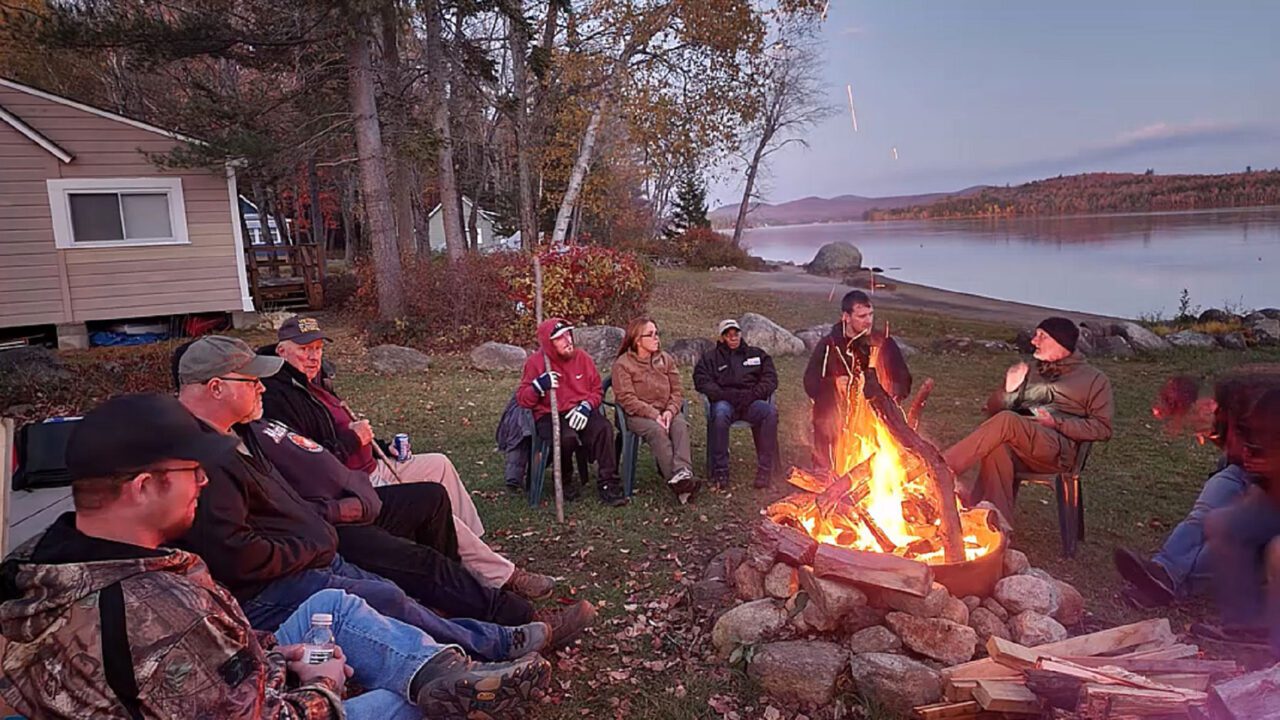 people around a campfire at homeward bound adirondacks retreat center