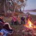 people around a campfire at homeward bound adirondacks retreat center