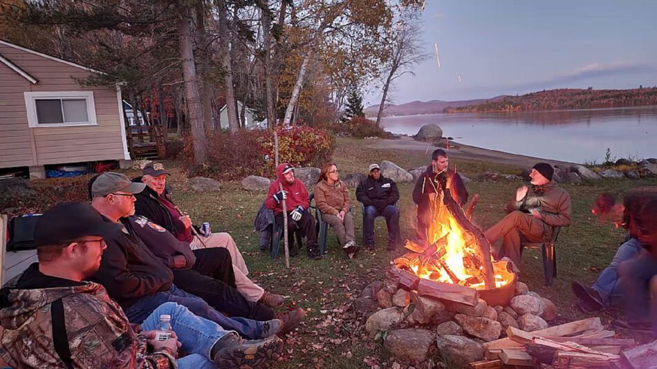 people around a campfire at homeward bound adirondacks retreat center