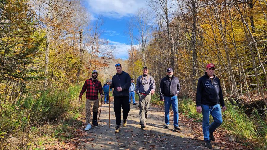 men walking on a dirt road