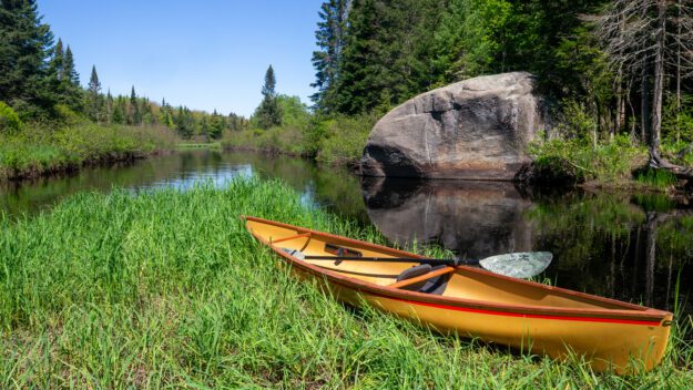 canoe on a grassy riverbank