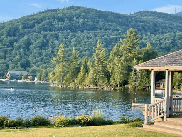 The forested mountainside and peninsula in the middle of the lake where the new home would be built.