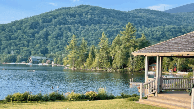 The forested mountainside and peninsula in the middle of the lake where the new home would be built.