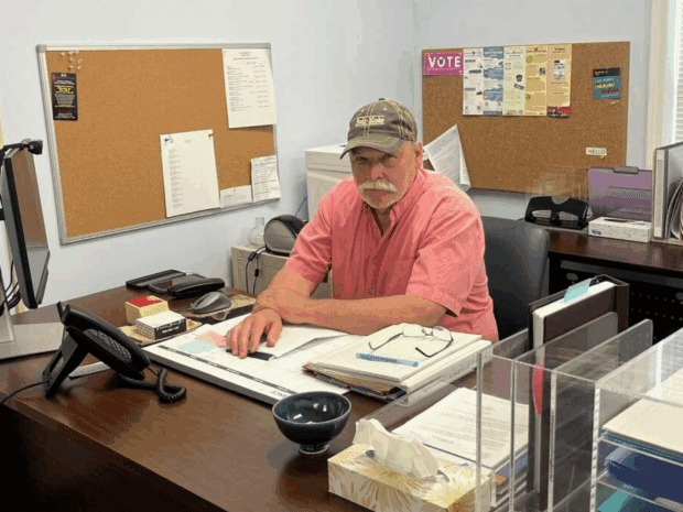 Marty Miller, the town supervisor of Potsdam, sits at his desk at Town Hall. Potsdam’s population declined by 1,523 residents between 2010 and 2024. Courtesy of Marty Miller